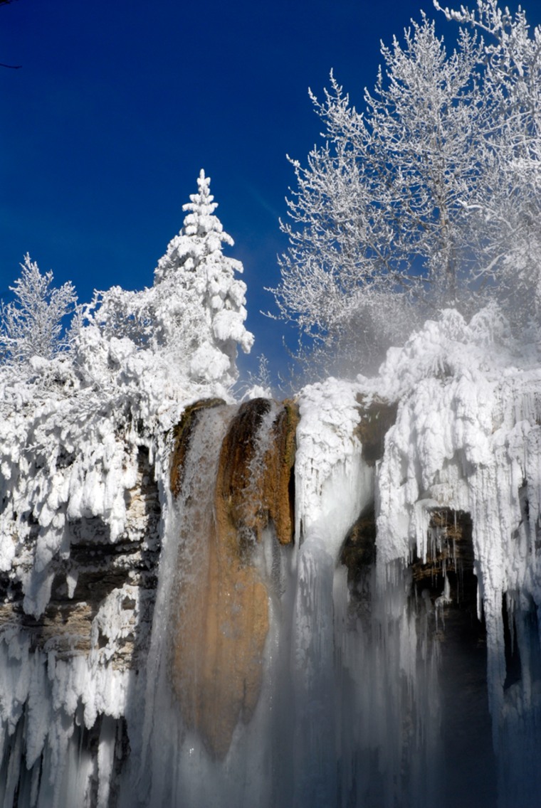 This undated photo released by the Fairmont Hot Springs Resort shows a partially frozen waterfall near the Fairmont Hot Springs Resort, roughly an hour north of Kimberley in British Columbia. The resort can be found along the Powder Highway, a collection of authentic rural Canadian ski resorts and one of the last uncovered winter destinations in North America. (AP Photo/Fairmont Hot Springs Resort) ** NO SALES **